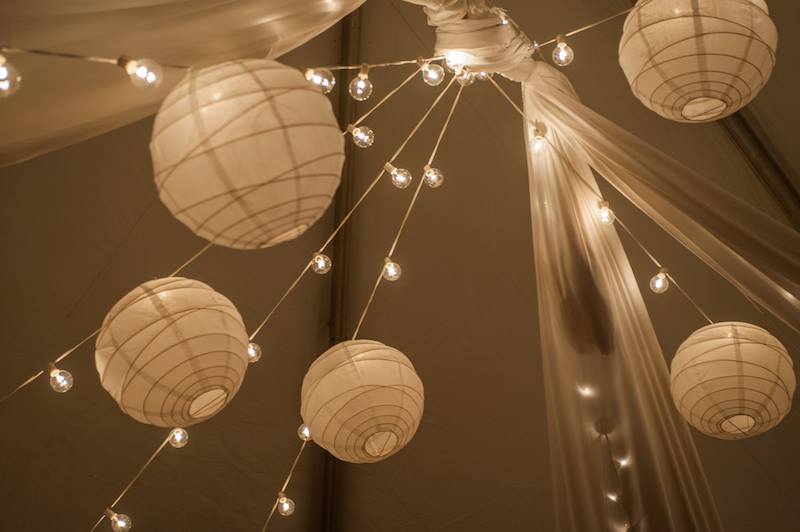 White Paper Lanterns Attached to Bistros in a Frame Tent