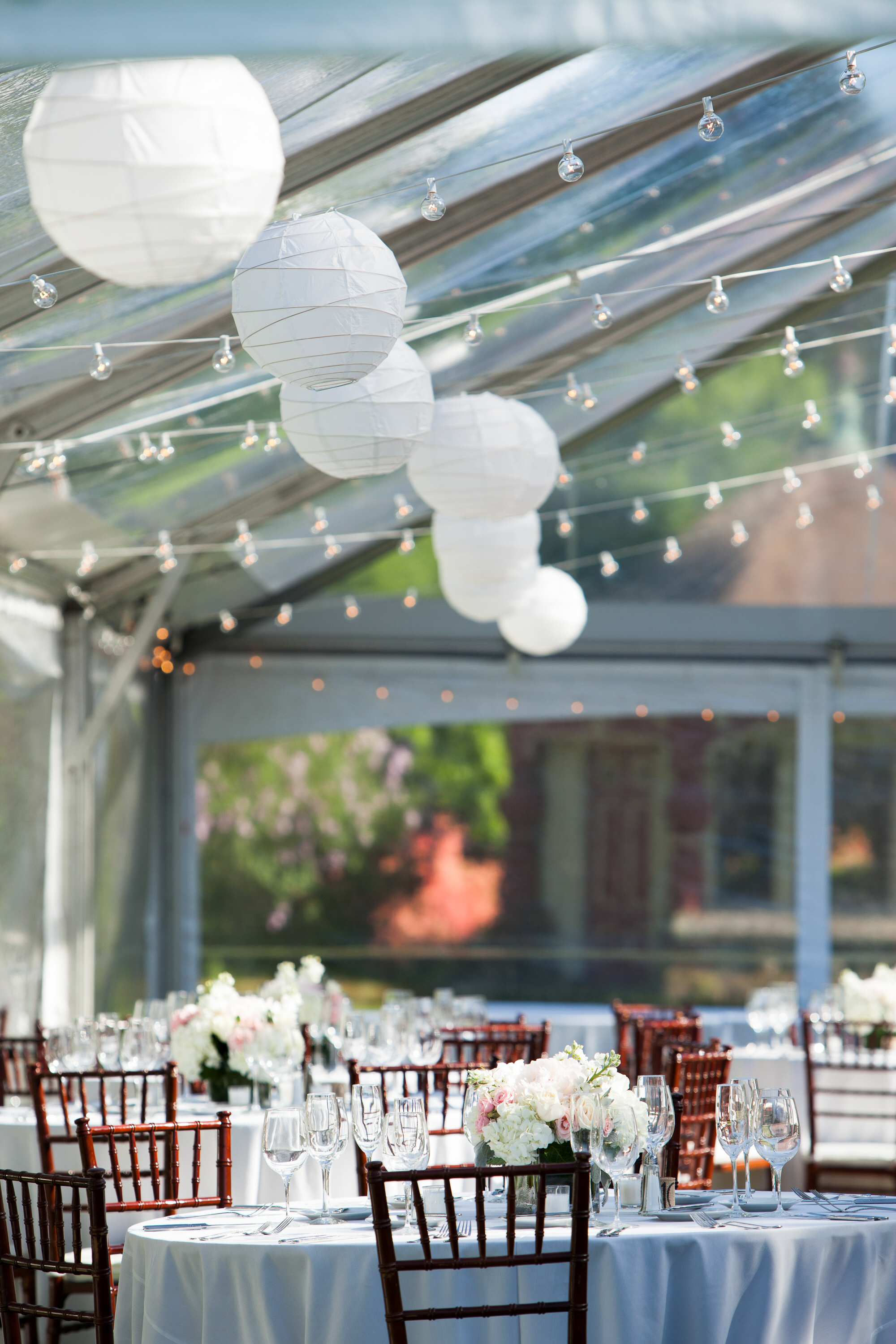 White Paper Lanterns Attached To Bistros in a Clear Frame Tent