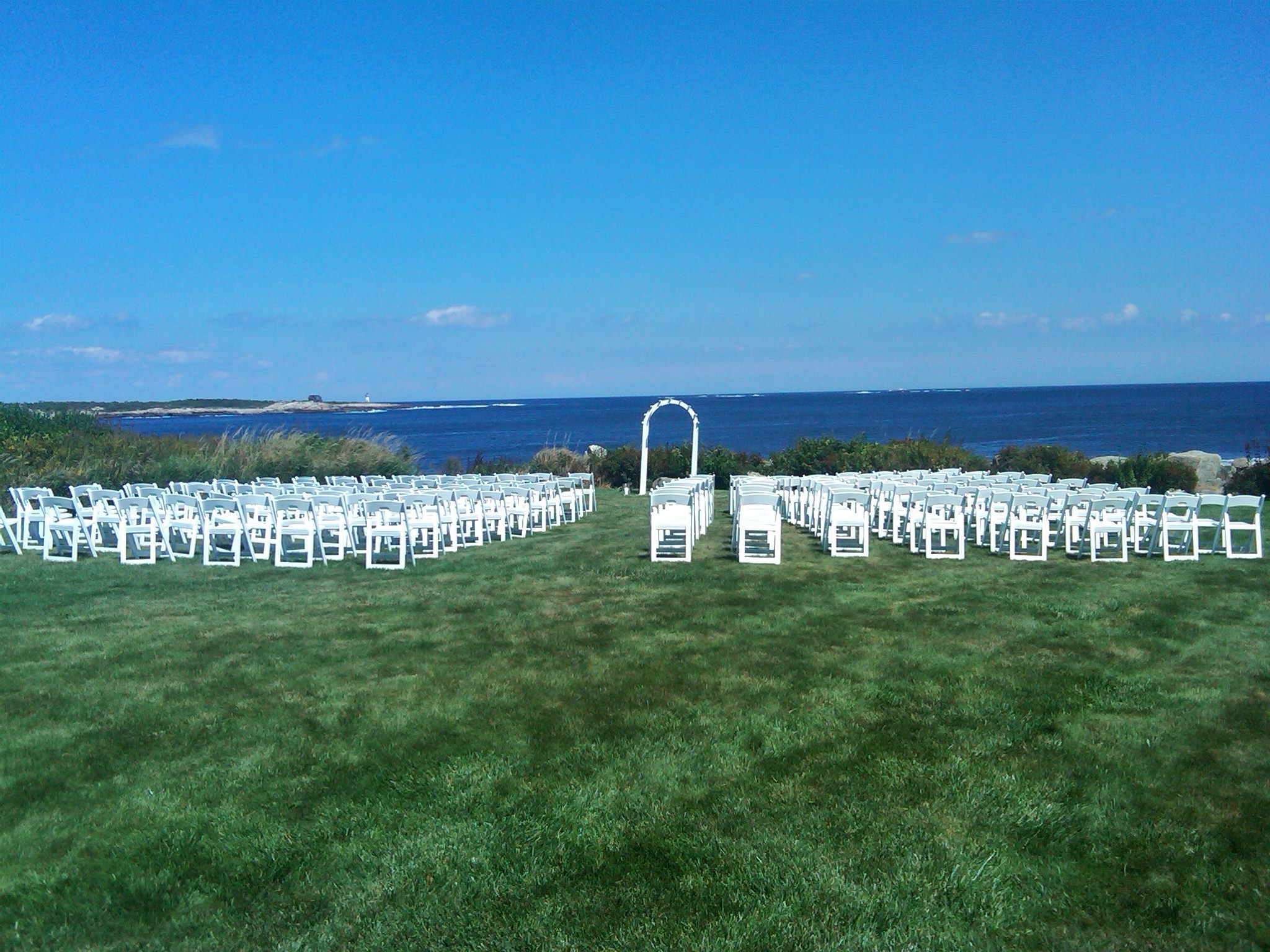 White Lattice Arch Set for Oceanside Ceremony